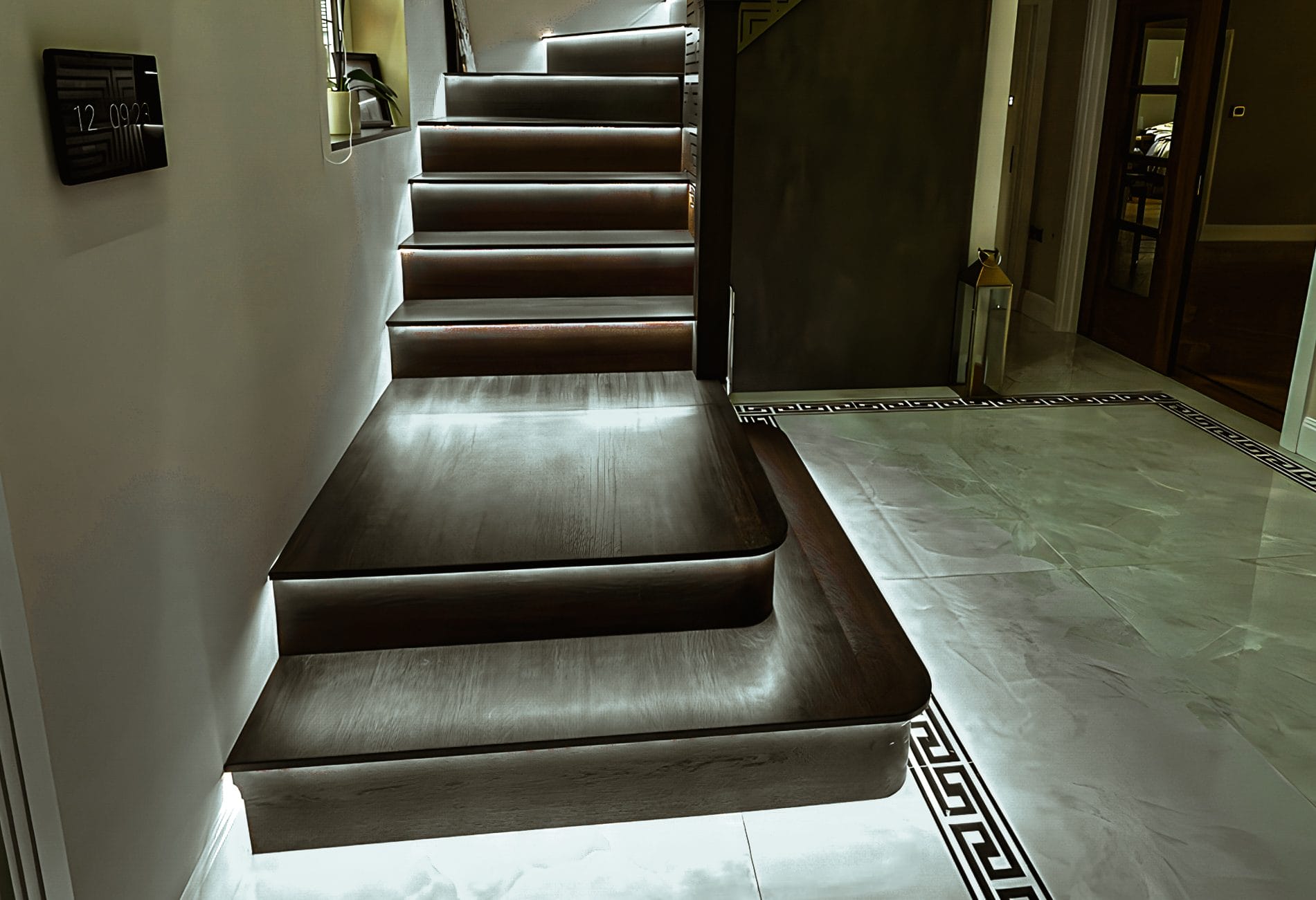 Bespoke staircase with stairs made out of walnut and LED strips lighting.