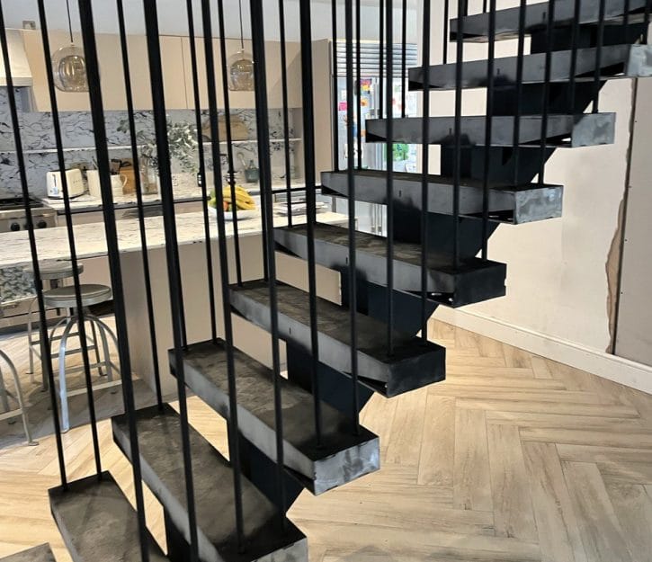 Our custom spine staircase, designed with elegant metal rod balustrades, meticulously constructed by V.P Stairs Ltd for superior style and durability.