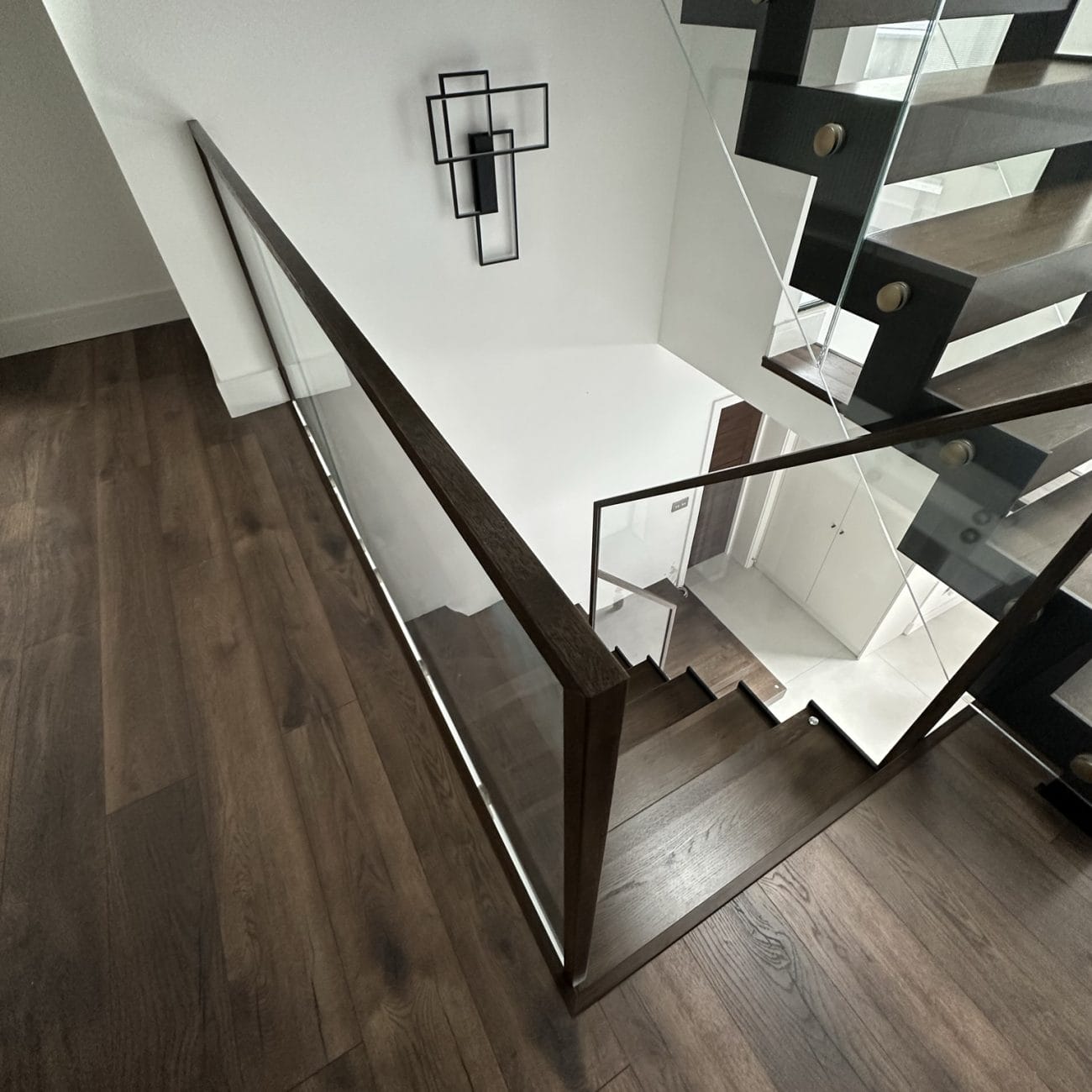 ZigZag staircase the structural steel and wood with transparent glass balustrades and sleek aluminium railings in UK