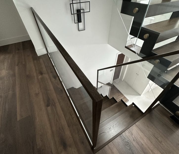 ZigZag staircase the structural steel and wood with transparent glass balustrades and sleek aluminium railings in UK