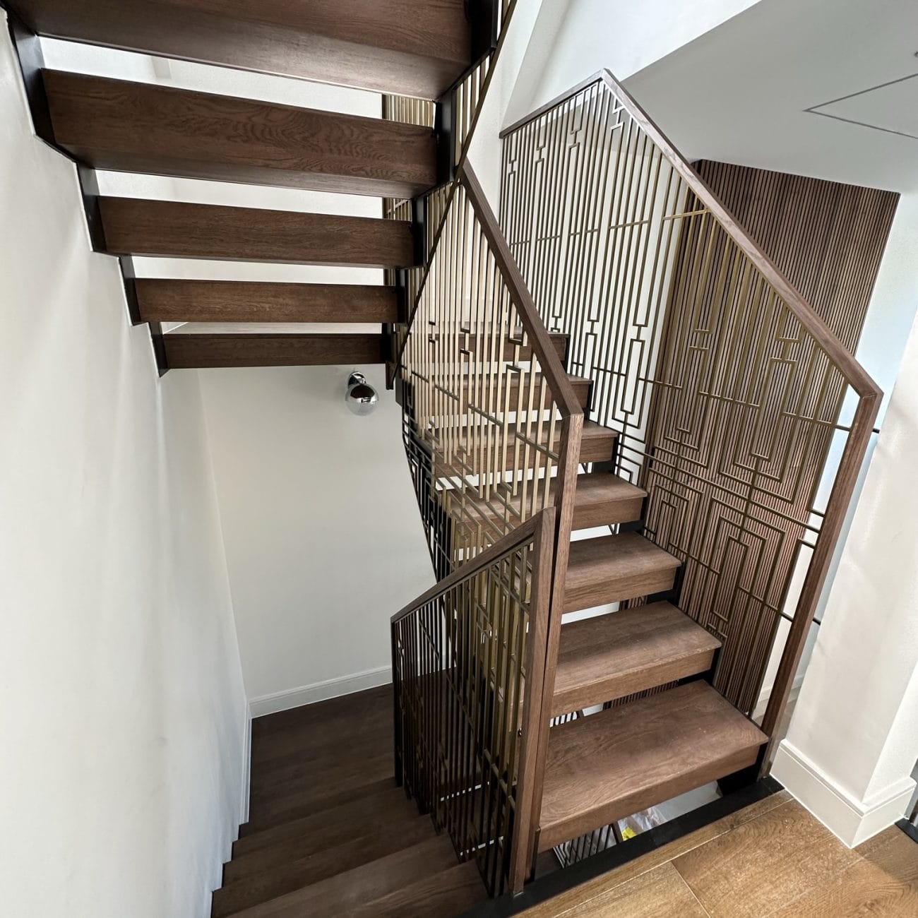 V.P Stairs Ltd specializes in luxury zig-zag staircases with walnut steps and stainless-coated metal balustrades, perfect for any high-end renovation.