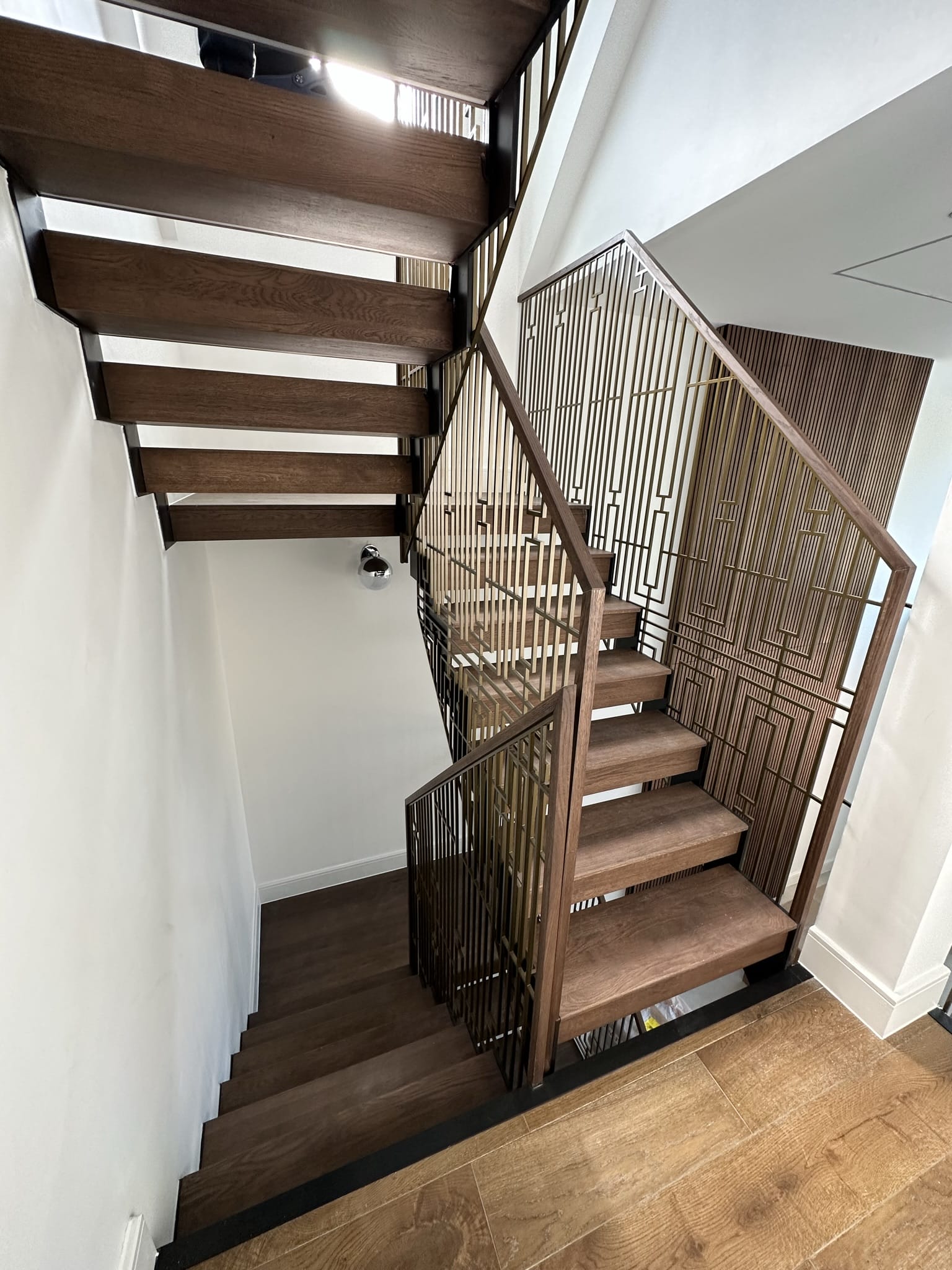 V.P Stairs Ltd specializes in luxury zig-zag staircases with walnut steps and stainless-coated metal balustrades, perfect for any high-end renovation.