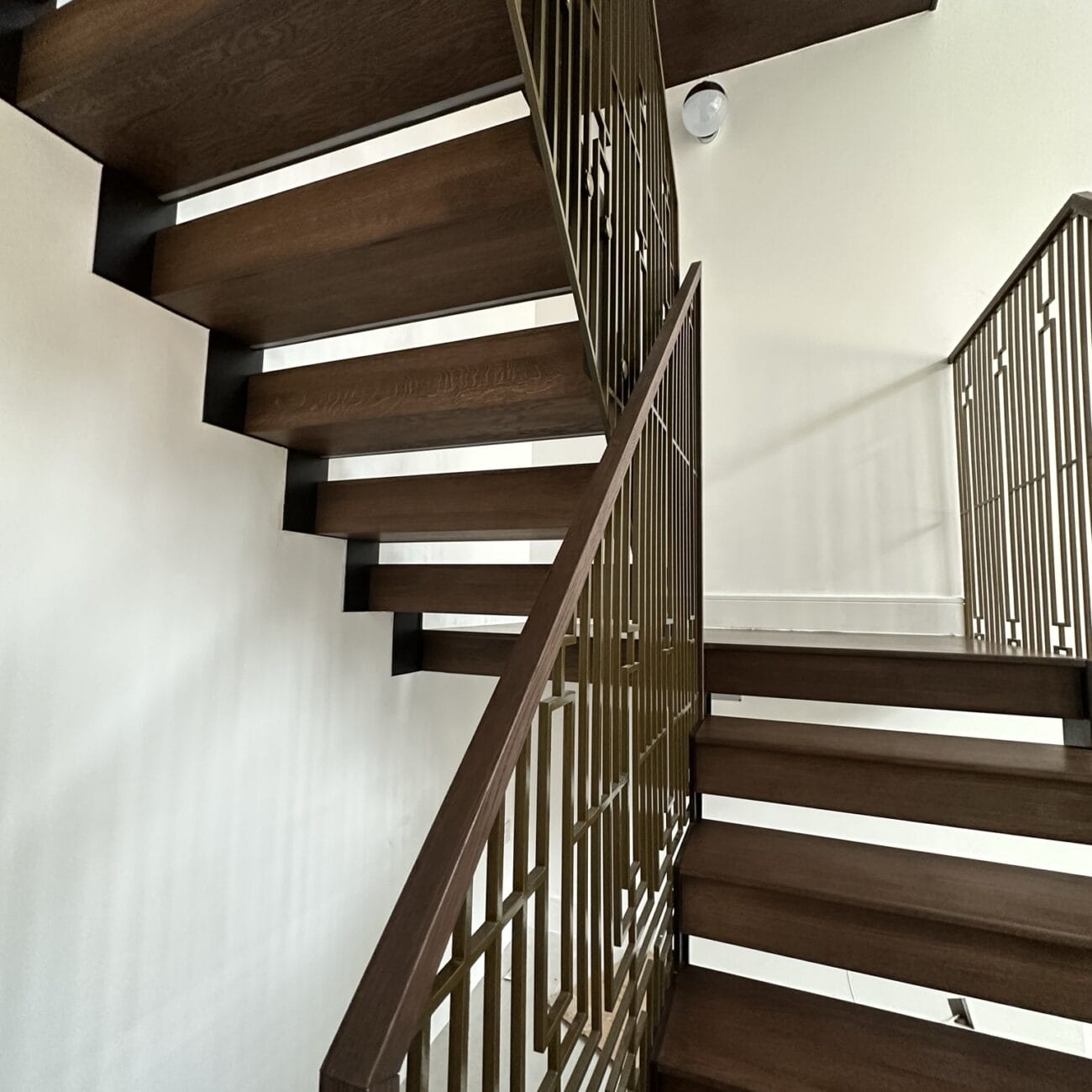 UK's finest craftsmanship shines in the Woodford staircase, a stunning blend of natural oak and modern steel.