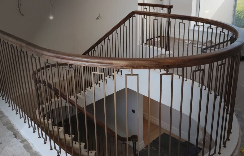Modern staircase with walnut handrail detail