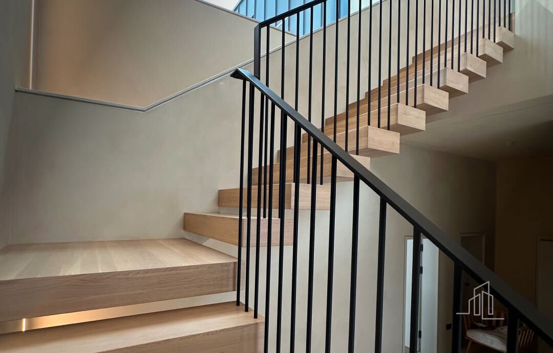 Modern staircase with painted metal balustrades and lighting