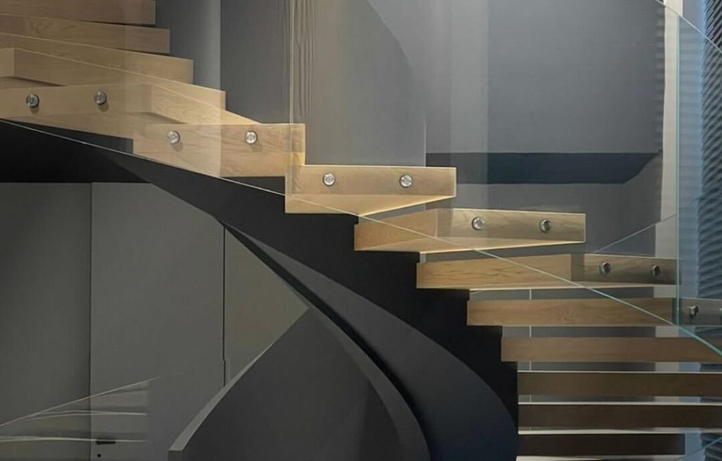 Halloween-themed glass floating staircase with pumpkins and cobwebs