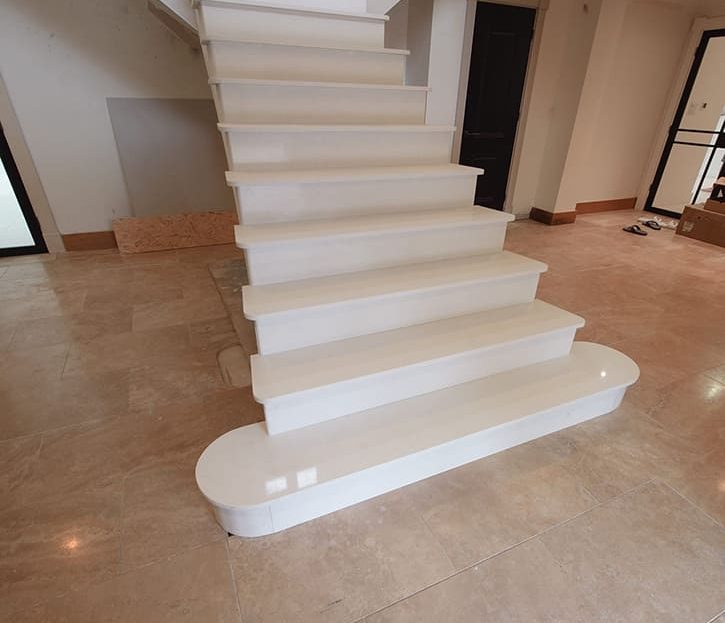 Polished white marble stair treads with refined texture on bespoke Peterborough staircase