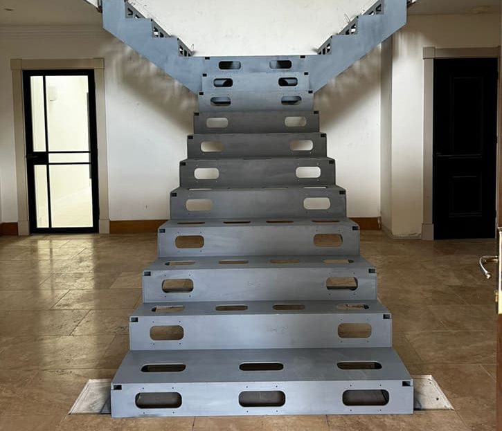 Unique T-shaped modern staircase design with white marble treads and steel structure