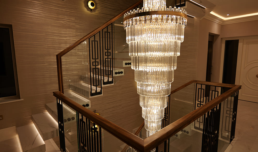 Floating staircase illuminated by central chandelier — Peckham project in luxury interior