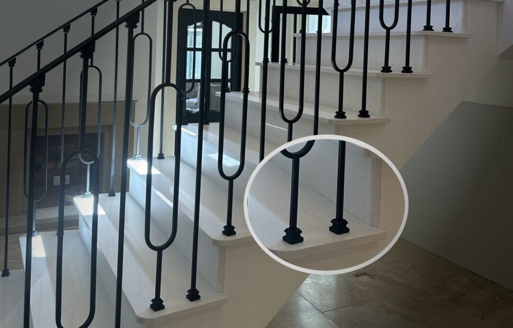 A close-up view of iron spin shoes for balustrades