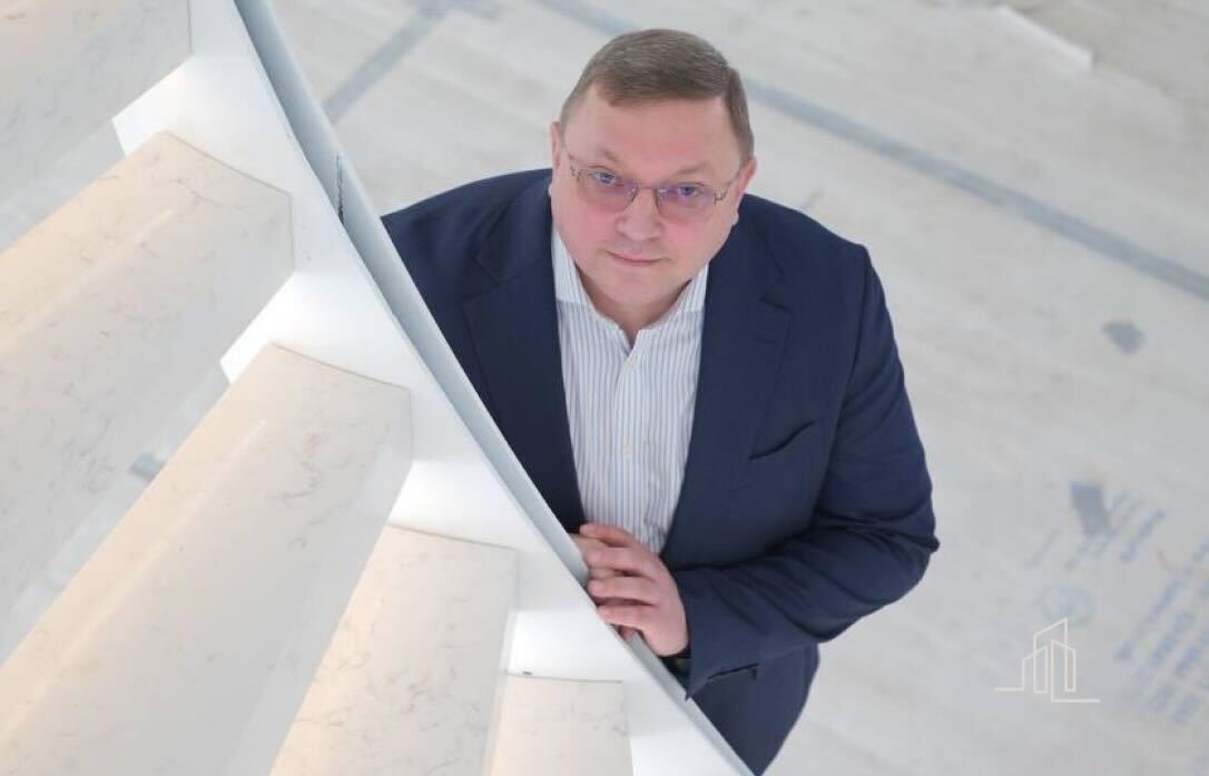 a man looking at a finished staircase