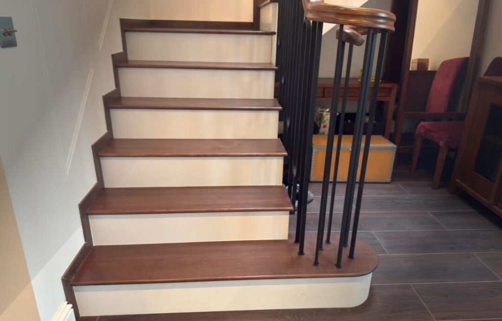 Slim wooden treads with a feature step and metal balustrades
