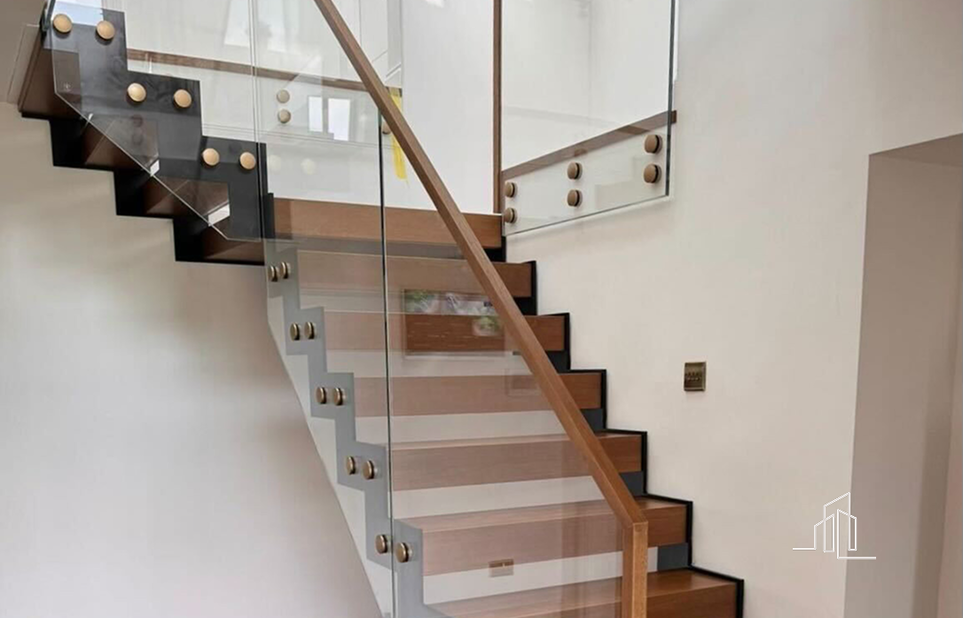 A modern staircase combining wood and glass balustrades
