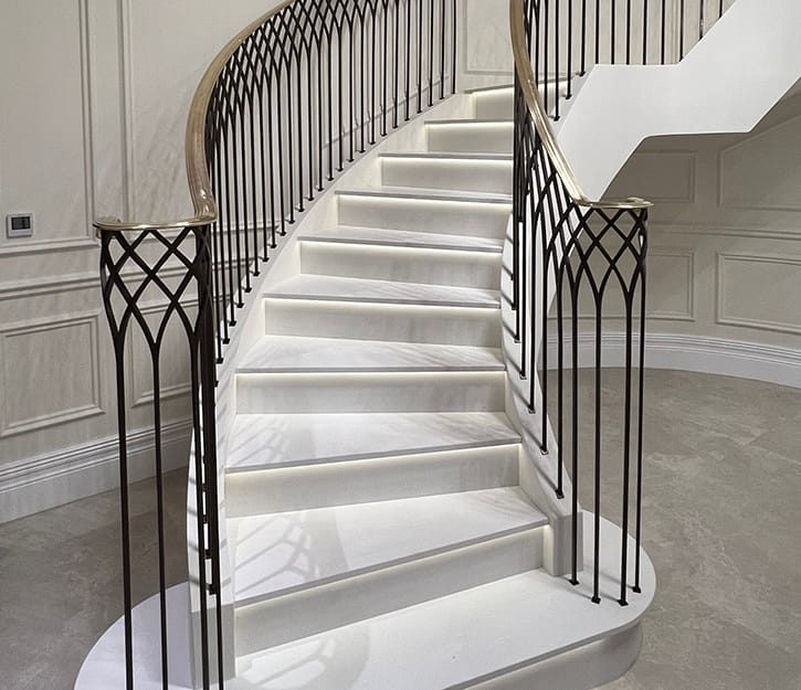 handcrafted bespoke balustrade with curved design and brass handrail