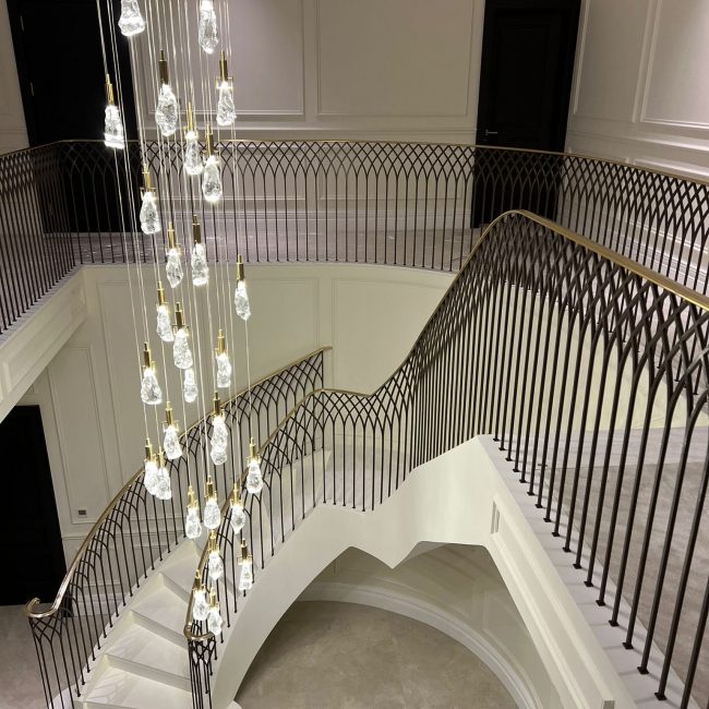feature step on bespoke curved staircase with antique brass balustrade