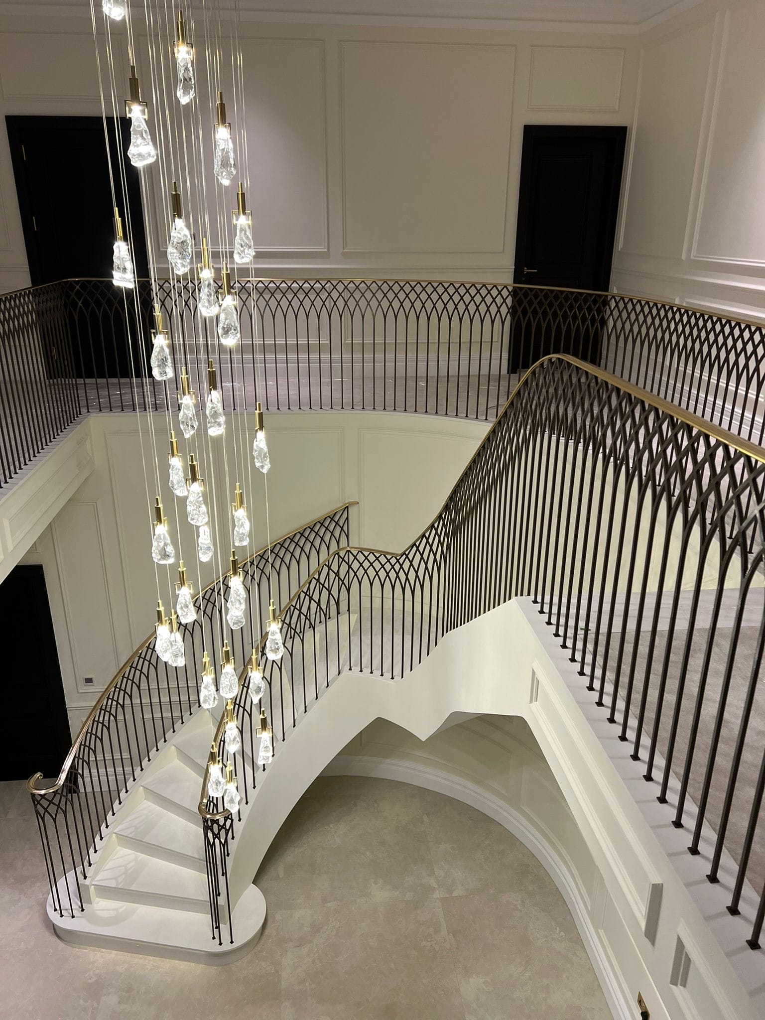 feature step on bespoke curved staircase with antique brass balustrade