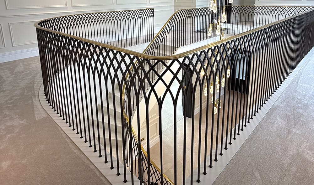 bespoke metal balustrade with antique brass finish and custom brass handrail