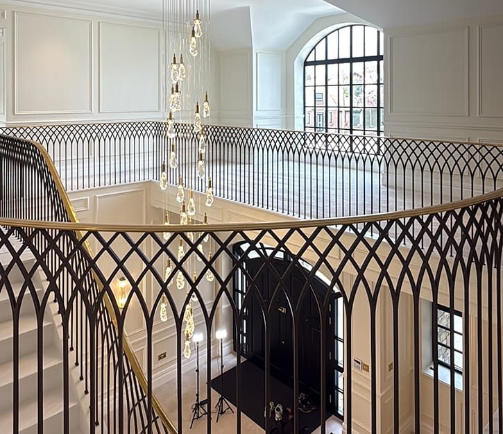 custom brass handrail and seamless metal balustrade on gallery landing