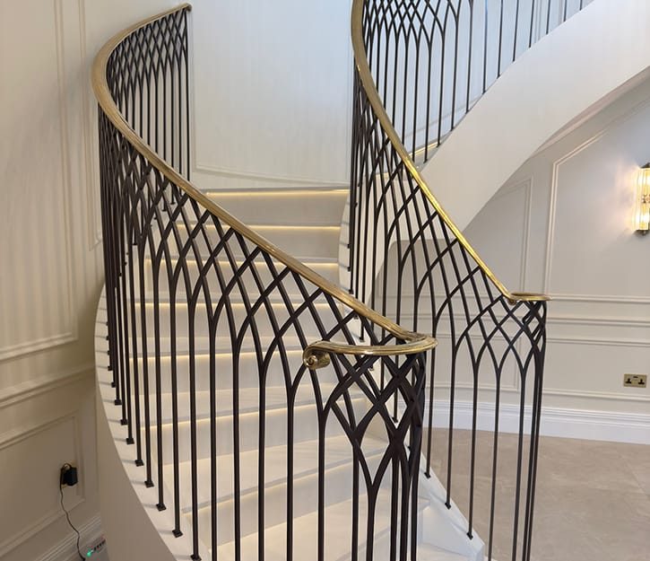 modern bespoke staircase with quartz steps and decorative metal balustrade