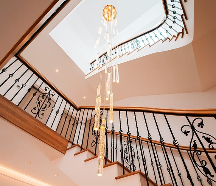Helical staircase with solid oak treads and handcrafted wrought iron balustrades by V.PSTAIRS in London